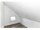 This attic room features wood-look floors and a window at 59 E Troy Ave, Indianapolis, IN 46225