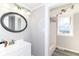Bright bathroom featuring modern vanity with an oval mirror and combination shower-tub at 59 E Troy Ave, Indianapolis, IN 46225