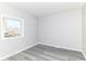 Serene bedroom with a bright window and gray flooring at 59 E Troy Ave, Indianapolis, IN 46225