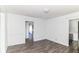 A bright bedroom with white walls and wood-look floors with doorframes at 59 E Troy Ave, Indianapolis, IN 46225