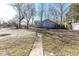 Exterior view of a home with a barren front yard, a sidewalk, and bare trees at 59 E Troy Ave, Indianapolis, IN 46225