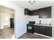 Kitchen featuring dark cabinets and laminate flooring at 59 E Troy Ave, Indianapolis, IN 46225