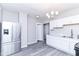 Stylish kitchen with stainless steel appliances, white cabinets, and durable gray floors at 59 E Troy Ave, Indianapolis, IN 46225