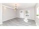 Spacious living room filled with natural light, featuring gray floors and a modern chandelier at 59 E Troy Ave, Indianapolis, IN 46225