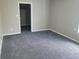 An empty bedroom featuring neutral paint, new carpet, and natural light from a window at 609 S Grant St, Martinsville, IN 46151