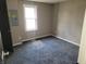 An empty bedroom featuring neutral paint, new carpet, and natural light from a window at 609 S Grant St, Martinsville, IN 46151