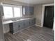 Updated kitchen with stainless steel sink, gray cabinets, modern countertops, and window view at 609 S Grant St, Martinsville, IN 46151
