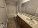 The bathroom has a double sink vanity, a large mirror, and a shower-tub combination at 6114 Arrowhead Dr, Anderson, IN 46013