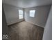 Bedroom with neutral walls, carpet flooring, and plenty of natural light at 6114 Arrowhead Dr, Anderson, IN 46013