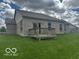 Exterior view of home featuring a backyard with a wooden deck and a well-maintained lawn at 6117 Arctic Cir, Indianapolis, IN 46237