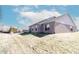 Backyard with a brick house that features a small wooden deck, windows, and a well-kept lawn at 6117 Arctic Cir, Indianapolis, IN 46237