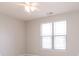 Bedroom featuring a ceiling fan, light grey walls, and a bright window with window blinds at 6117 Arctic Cir, Indianapolis, IN 46237
