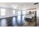Open-concept living space features hardwood floors, natural light, and a modern kitchen at 6117 Arctic Cir, Indianapolis, IN 46237