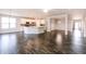 Open-concept living room with stainless appliances, island, and hardwood-style flooring at 6117 Arctic Cir, Indianapolis, IN 46237
