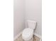 A white toilet in a neutral-toned bathroom at 6117 Arctic Cir, Indianapolis, IN 46237