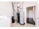Utility room with water heater, washer, dryer and open doorway at 6117 Arctic Cir, Indianapolis, IN 46237