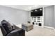 Finished basement with a large TV, built-in shelving, comfortable seating and plush carpet providing a cozy atmosphere at 6126 Golden Eagle Dr, Zionsville, IN 46077