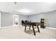 View of a finished basement featuring a foosball table, arcade game, and ample open space for various activities at 6126 Golden Eagle Dr, Zionsville, IN 46077