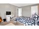 Serene bedroom showcasing a functional desk, a bed with patterned bedding, and calming gray walls at 6126 Golden Eagle Dr, Zionsville, IN 46077
