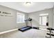 Well-lit workout room featuring a treadmill and wall mirror at 6126 Golden Eagle Dr, Zionsville, IN 46077