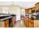 Well-lit kitchen with granite countertops, wood cabinets, and a view to the dining area at 6126 Golden Eagle Dr, Zionsville, IN 46077