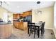 Bright kitchen with dark countertops, wooden cabinets, and a modern chandelier above the dining table at 6126 Golden Eagle Dr, Zionsville, IN 46077