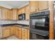 Close up of the kitchen features granite countertops, wooden cabinets, and stainless steel appliances at 6126 Golden Eagle Dr, Zionsville, IN 46077
