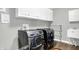Well-lit laundry room featuring front-load washer and dryer and white cabinets at 6126 Golden Eagle Dr, Zionsville, IN 46077