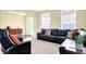 Comfortable living room features neutral carpet and a large leather sofa at 6126 Golden Eagle Dr, Zionsville, IN 46077