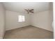 An empty room with carpet, a ceiling fan, and a window at 615 Conner Creek Dr, Fishers, IN 46038