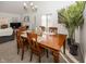 Cozy dining area featuring a wood table, chandelier lighting, and a large window for natural light at 615 Conner Creek Dr, Fishers, IN 46038