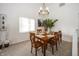 Well-lit dining area with a wooden table set for six, complemented by a modern chandelier and neutral decor at 615 Conner Creek Dr, Fishers, IN 46038