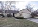 Charming single-story home with stone and siding, features an attached garage and a well-maintained front yard at 615 Conner Creek Dr, Fishers, IN 46038