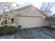 Attached garage with a large door, stone accent wall and seasonal floral decoration at 615 Conner Creek Dr, Fishers, IN 46038