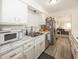 Well-equipped kitchen with white cabinetry, stainless steel appliances, and ample counter space at 615 Conner Creek Dr, Fishers, IN 46038