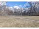 Community tennis court surrounded by bare trees under a partly cloudy sky at 615 Conner Creek Dr, Fishers, IN 46038