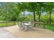 Inviting wooden deck featuring an outdoor dining set, ideal for enjoying the serene backyard at 6530 Grant Wood Ct, Indianapolis, IN 46256