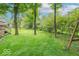 Expansive backyard with mature trees and lush green grass, offering plenty of space for recreation and relaxation at 6530 Grant Wood Ct, Indianapolis, IN 46256