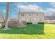 Spacious backyard featuring a large deck, lush green lawn, and mature trees at 6530 Grant Wood Ct, Indianapolis, IN 46256