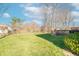 Expansive backyard features lush green grass, mature trees, and a wooden deck perfect for outdoor entertaining and relaxation at 6530 Grant Wood Ct, Indianapolis, IN 46256