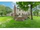 Lush backyard featuring a spacious deck, mature trees, and a well-manicured lawn, perfect for outdoor activities at 6530 Grant Wood Ct, Indianapolis, IN 46256