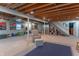 Finished basement with carpet floors and access to the upper level via staircase at 6530 Grant Wood Ct, Indianapolis, IN 46256