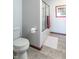 Clean, well-maintained bathroom featuring a toilet, towel rack, and a glass-enclosed shower and tub at 6530 Grant Wood Ct, Indianapolis, IN 46256