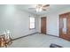 Well-lit bedroom with a rocking chair, ceiling fan, and natural light from the window at 6530 Grant Wood Ct, Indianapolis, IN 46256