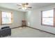 Bright room with a rocking chair and natural light streaming through two windows at 6530 Grant Wood Ct, Indianapolis, IN 46256