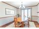 Bright dining room featuring an oval table, six chairs, and a bay window for natural light at 6530 Grant Wood Ct, Indianapolis, IN 46256