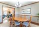 Inviting dining room with an oval table, six chairs, and a view of the living room at 6530 Grant Wood Ct, Indianapolis, IN 46256