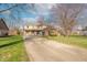 Inviting two-story home with a long driveway, a brick facade, and a well-manicured lawn at 6530 Grant Wood Ct, Indianapolis, IN 46256