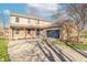 Attractive two-story home with a brick facade, covered porch, and a blue garage door at 6530 Grant Wood Ct, Indianapolis, IN 46256