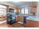 Kitchen with maple cabinets, granite counters, stainless appliances, hardwood flooring and breakfast bar at 6530 Grant Wood Ct, Indianapolis, IN 46256